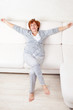 Photo: Happy mature woman on sofa Happy mature woman on sofa