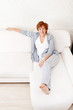 Photo: Happy mature woman on sofa Happy mature woman on sofa