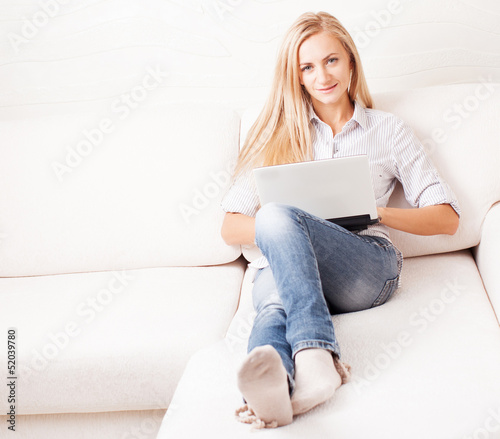 Photo: Woman on the sofa with laptop Woman on the sofa with laptop
