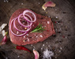 Photo: Raw beef steak on wooden table Raw beef steak on wooden table