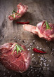 Raw beef steaks and lamb chops on wooden table