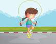 A little girl playing jumping rope at the road