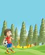 A young boy holding a soccer ball near the pine trees
