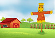 A farm with a barn and a scarecrow