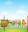 An empty wooden arrowboard near the hanging clothes