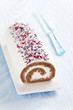 Roll cake with black tea, spices and dried flower petals