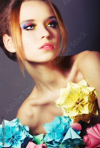 Photo: Young Beauty with Colorful Origami Flowers. Bright Eye Make-Up Young Beauty with Colorful Origami Flowers. Bright Eye Make-Up