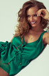 Photo: Young attractive woman is smiling and lying on the studio backgr Young attractive woman is smiling and lying on the studio backgr