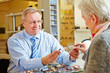 Optician giving consultation to senior woman