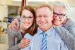 Family with seniors at optician with glasses