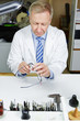 Optician in workshop fixing glasses