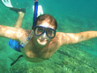 man wearing a mask and flippers dives into the sea with pleasure