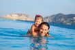 Father  with his daughter swimming in pool