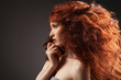 Photo : Beautiful woman with curly hairstyle against gray background Beautiful woman with curly hairstyle against gray background