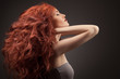 Photo : Beautiful woman with curly hairstyle against gray background Beautiful woman with curly hairstyle against gray background