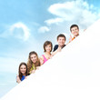 Group of teenagers with a giant, blank, white billboard