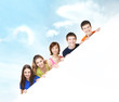 Group of teenagers with a giant, blank, white billboard