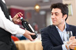 Photo: Waiter suggesting a bottle of wine to a customer Waiter suggesting a bottle of wine to a customer