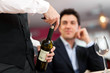 Foto: Waiter serving wine to a customer Waiter serving wine to a customer
