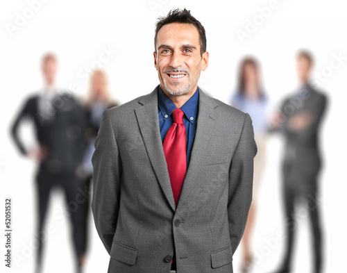 Photo: Businessman in front of his team Businessman in front of his team