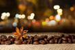 Coffee and Star Anise on sackcloth background with night lights