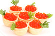 Red caviar in tartlets on white plate close-up