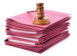 Judge gavel and soundboard on stack of files isolated