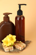 Liquid and hand-made soaps on beige background