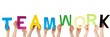 hands holding TEAMWORK