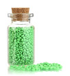 Little bottle full with colorful beads isolated on white