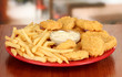Fried chicken nuggets with french fries and sauce