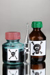 Deadly poison in bottles on grey background