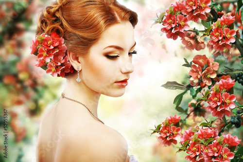 Photo: Red Hair Beauty over Natural Floral Background. Nature. Blossom Red Hair Beauty over Natural Floral Background. Nature. Blossom