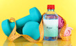 Dumbbells on yellow background
