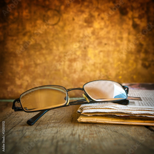 Photo: Rading glasses and newspaper Rading glasses and newspaper