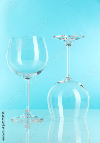 Photo: Two glasses on light blue background Two glasses on light blue background