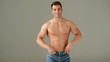 Muscular Man Showing His Biceps Against Gray Background