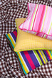 Three various pillows on plaid