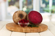 Sliced beetroot on board on wooden table on window background