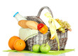 Picnic basket with fruits and bottle of milk, isolated on white