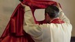Catholic priest dressing in church before serving mass