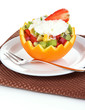 Fruit salad in hollowed-out orange isolated on white