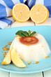 Lemon Panna Cotta with orange zest and caramel sauce,