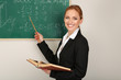 Portrait of teacher woman near the chalkboard in classroom