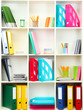Photo: White office shelves with different stationery, close up White office shelves with different stationery, close up