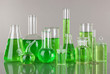 Test-tubes with green liquid on gray background