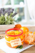 Orange jam with zest and tangerines, on wooden table