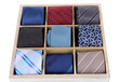 Neckties in wooden box isolated on white