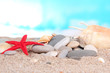 Sea stones on sand on bright background