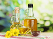 Useful linseed oil on wooden table on natural background
